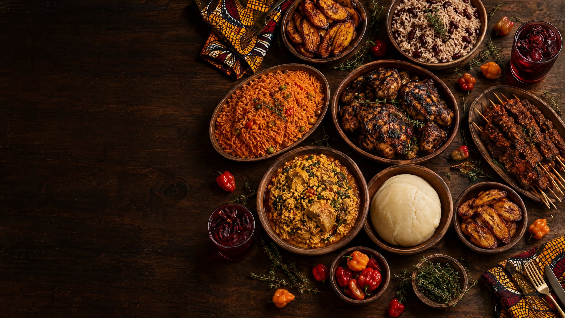 Overhead view of a table covered in bowls of West African and Caribbean dishes