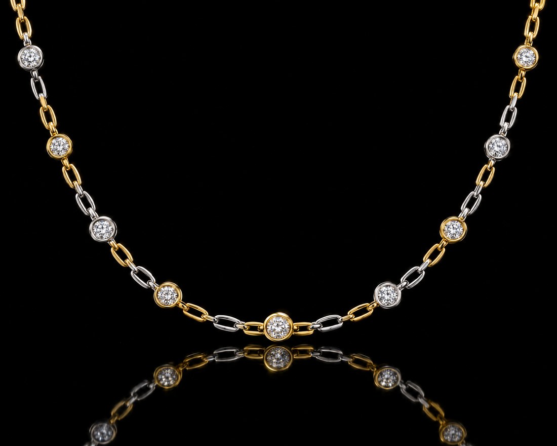 Bezel-set diamond station necklace in alternating yellow and white gold
