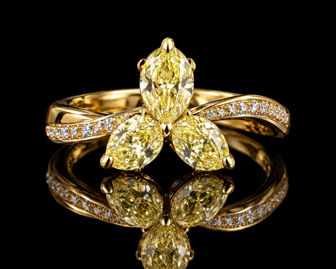three marquise-cut yellow diamonds in a cluster on a yellow gold band