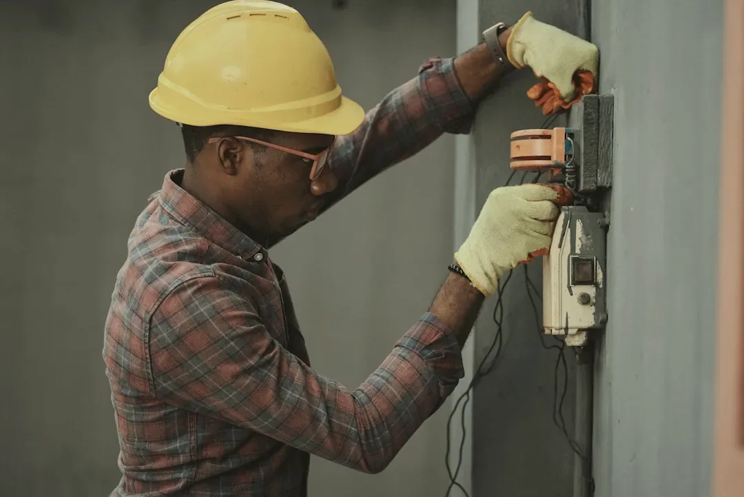 Electrician in a hard hat at work on a job site
